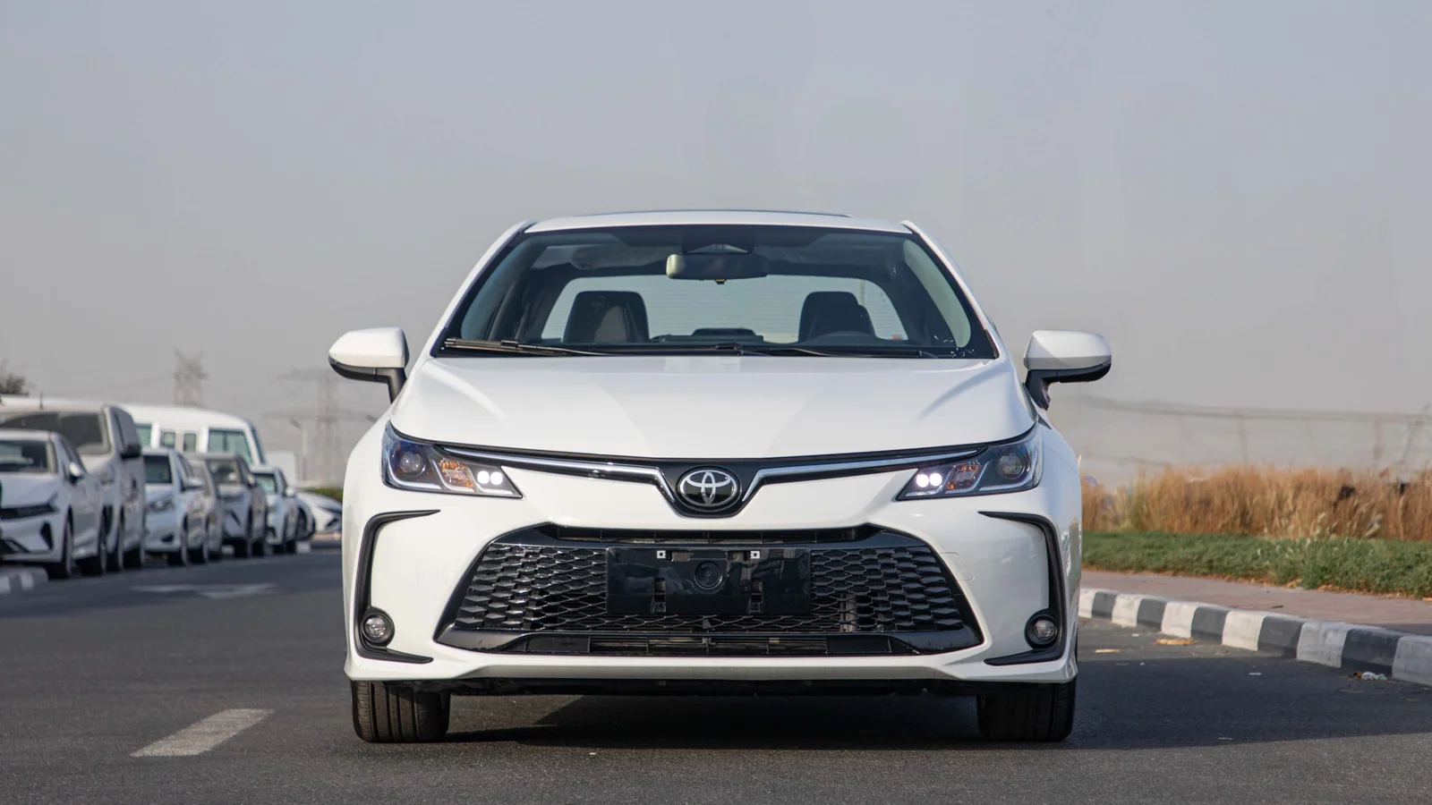 2025 Toyota Corolla Hybrid front view in white – premium sedan design
